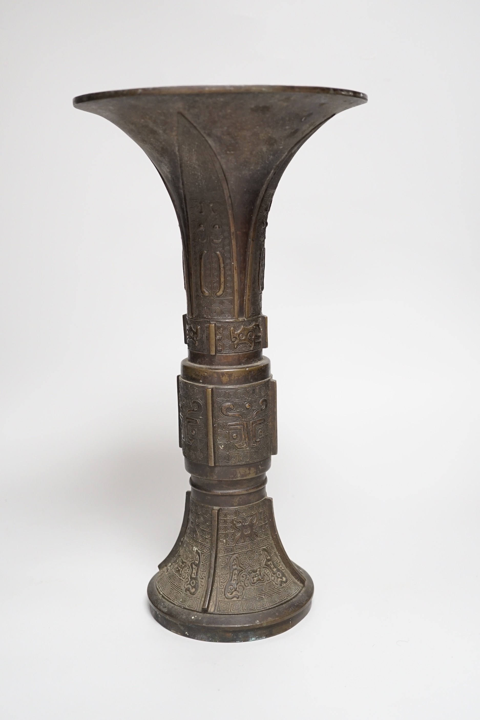 An 18th/19th century Chinese archaistic bronze beaker vase, gu, 34cm high